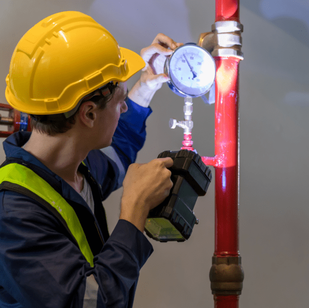 Fire inspector examining a building's fire sprinkler system.